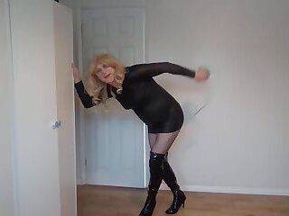 Leather dress, fishnets, boots and whip - ashemaletube.com